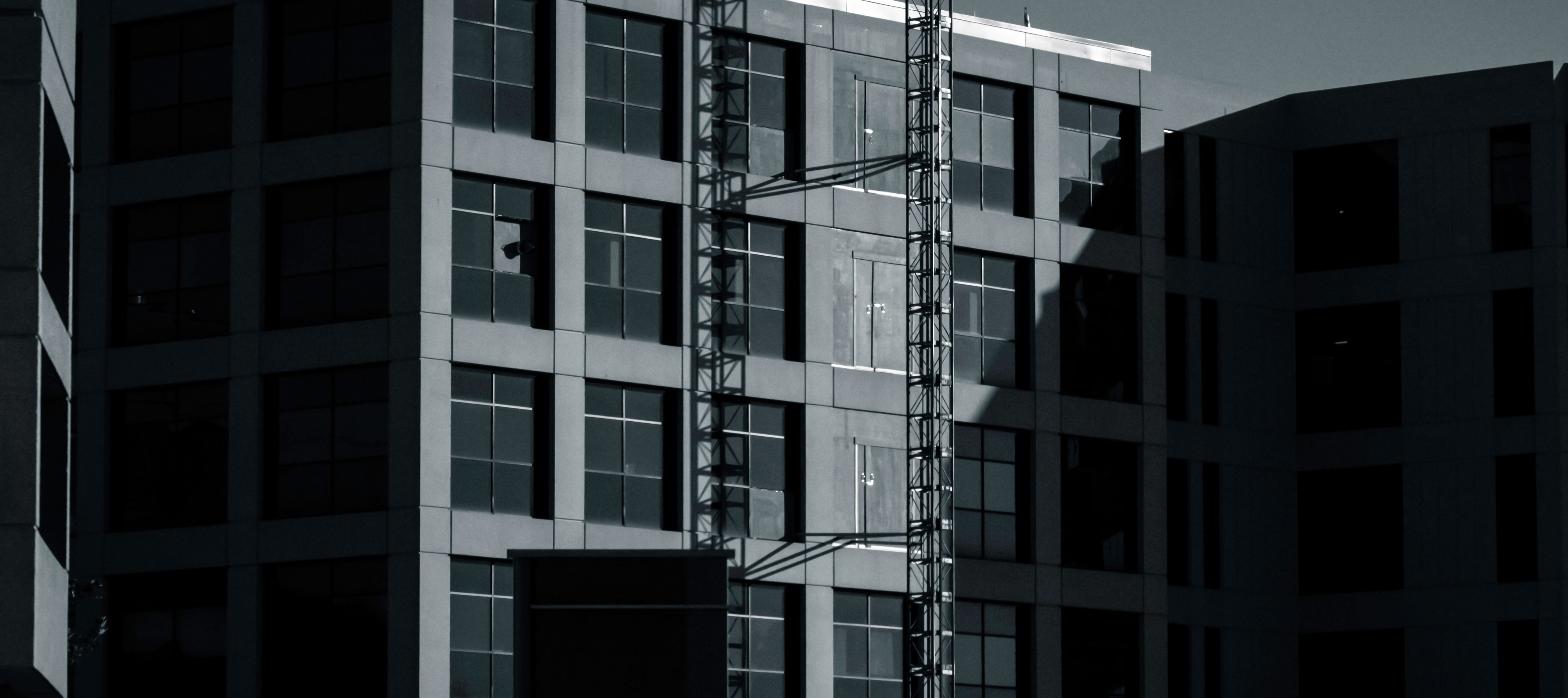 Modern multi-story medical office building exterior, representing the micro-hospital renovation.