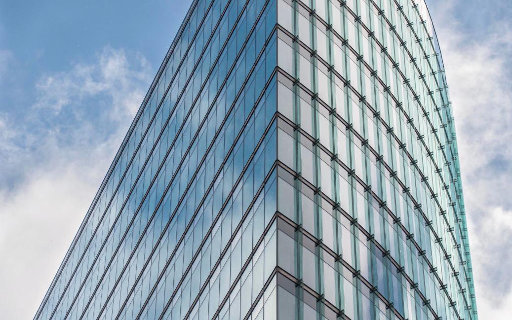 Modern glass office tower facade, representing a new medical office building in Delaware County.