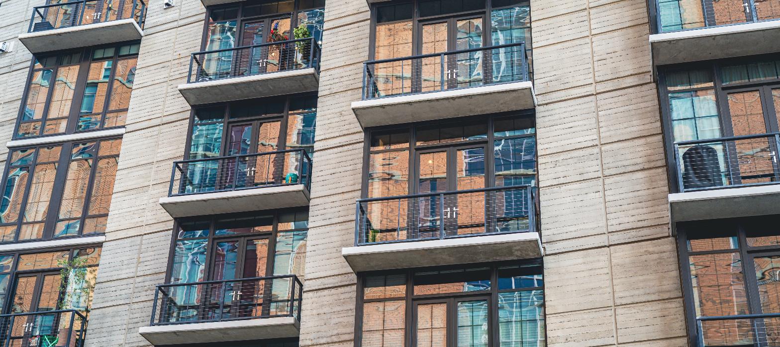 Modern apartment building exterior with balconies, representing a multifamily rehab financing deal.