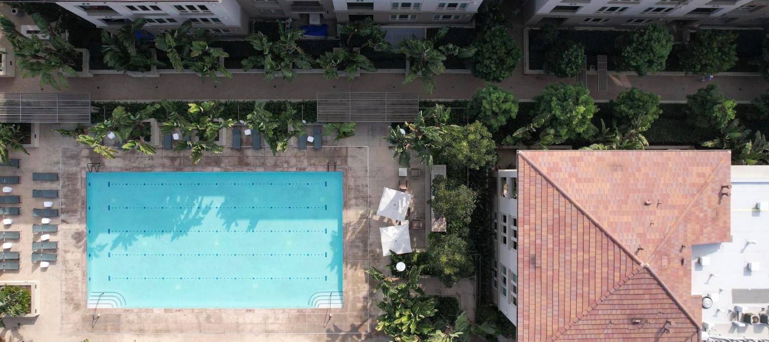 Aerial view of an apartment complex courtyard with a swimming pool, representing a multifamily property refinance.