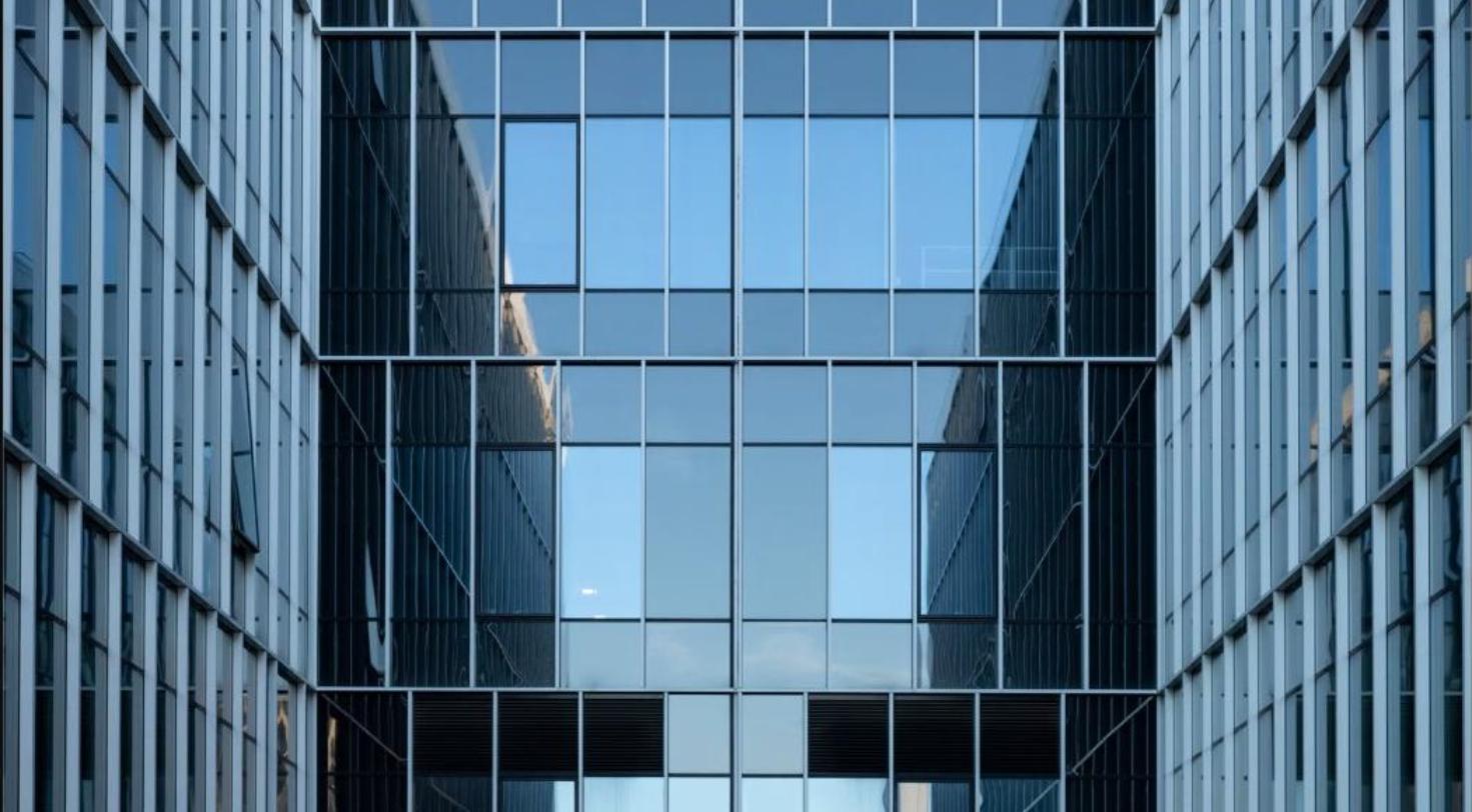 Modern glass office building facade, representing a bank branch repositioning.