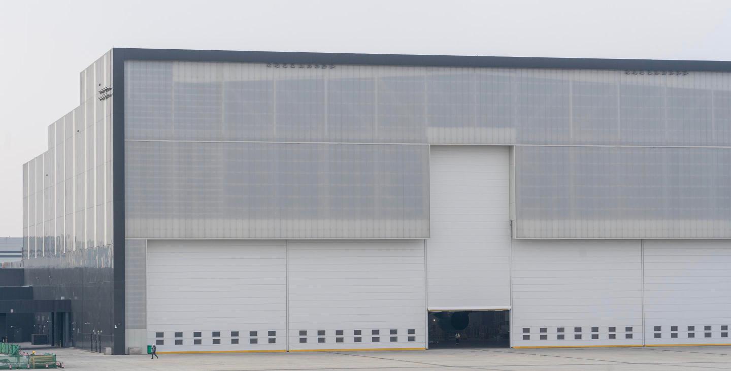 Modern gray industrial warehouse exterior with loading doors, representing a Bucks County distribution building.